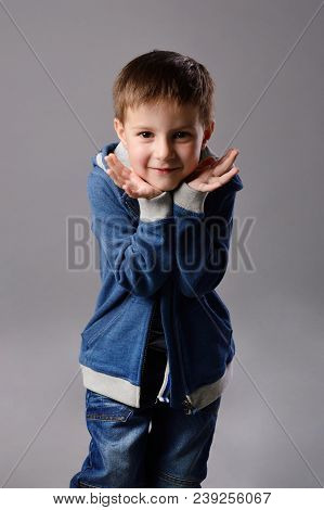 Fine-looking European Boy Is Smiling, He Is Very Happy And His Arms Are Close To  Face. His Arms Are