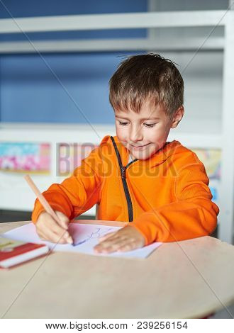 Cute Caucasian Boy Is Drawing At Home.