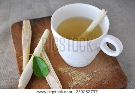 White Cup Of Fresh Lemongrass Tea With Fresh Lemongrass On Wooden Board