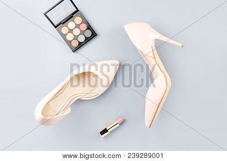 Pale Pink Female Shoes, Lipstick And Eyeshadow Palette On Grey Background. Fashion Blogger Concept F
