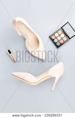 Pale Pink Female Shoes, Lipstick And Eyeshadow Palette On Grey Background. Fashion Blogger Concept F