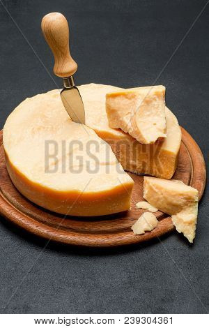 Whole Round Head And Pieces Of Parmesan Or Parmigiano Hard Cheese