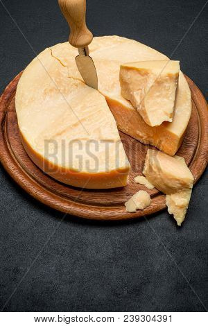 Whole Round Head And Pieces Of Parmesan Or Parmigiano Hard Cheese