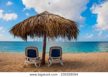 Sun Loungers And Parasols At The Paradise Beach. Cuba. Trinidad. Beautiful Tropical Ancona Beach. Ca