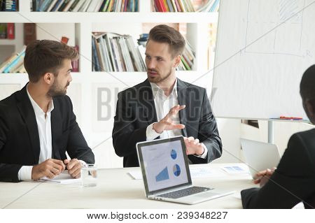 Business Worker Explaining New Startup Project To Colleague, Analyzing Company Reports And Annual Re