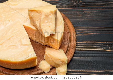 Whole Round Head And Pieces Of Parmesan Or Parmigiano Hard Cheese