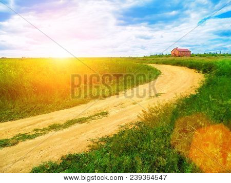 A Charming Sunrise. Beautiful Nature. Turn The Dirt Road. House On The Horizon. Blue Sky. Green Gras