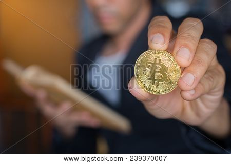 Blurred Business Man Lerning Book Method Of Money With Holding Gold Bitcoin Coin