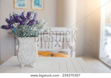 Bautiful Purple Flower In Vintage Flower Pot On White Table With Sun Lighting From Window