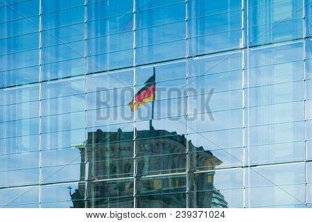 Reflection Of The German Flag On Reichstag Building In Modern Glass Facade
