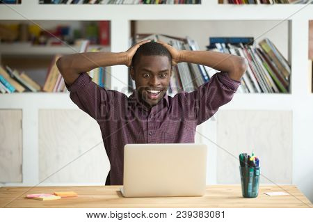 Excited African American Worker Looking Eyes Wide Open Winning Lottery Online, Not Believing His Luc