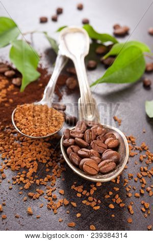 Instant Coffee And Roasted Beans With Coffea Leaves On Dark Sufrace.