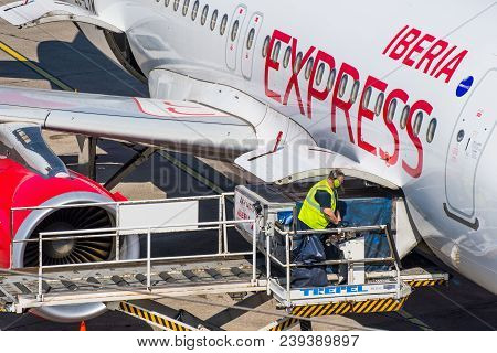 Berlin Germany - April 21. 2018: Handling Agent Unloading An Iberia Express Airplane At Berlin Tegel
