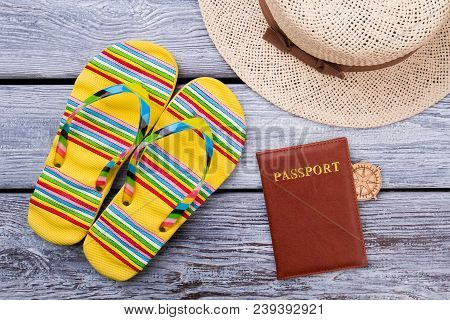 Beach Flat Lay With Passport. Travel And Beach Concept. Flip-floppers, Passport And Straw Hat. Grey 