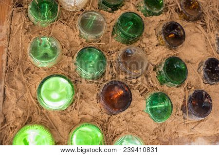 Close Up Of Bottle Wall Made With Cob And Recycled Bottles. Ecologycal Building Construction