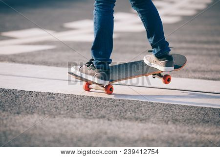 One Young Skateboarder Sakteboarding On Highway Road