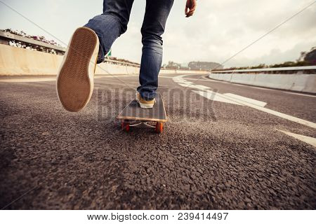 One Young Female Skateboarder Sakteboarding On Highway