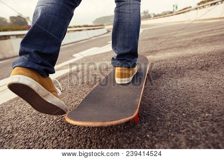 One Young Female Skateboarder Sakteboarding On Highway