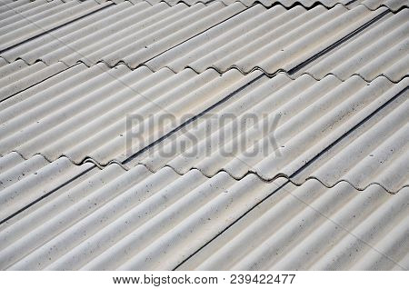 A Fragment Of A Gray Slate Roof Of An Old Sample Made Of Asbestos Material