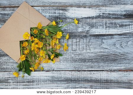 Yellow Little Flowers In Envelope Rustic Wooden Background