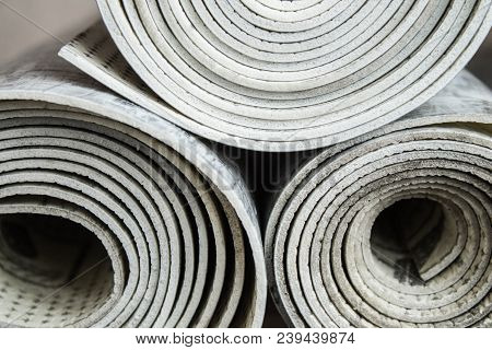 Gray Linoleum Rolled Up, Cut Into Pieces