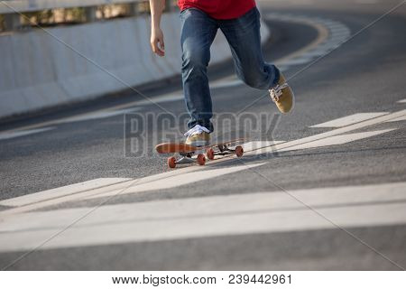 Closeup Of Skateboarder Sakteboarding On City Highway