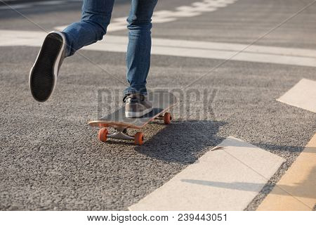 Closeup Of Skateboarder Sakteboarding On City Highway