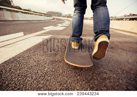 Closeup Of Skateboarder Sakteboarding On City Highway