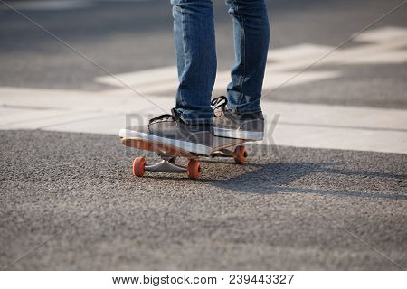 Closeup Of Skateboarder Sakteboarding On City Highway