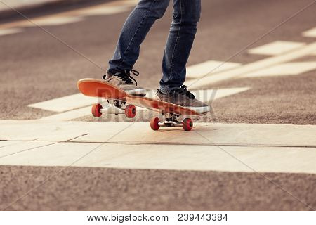 Closeup Of Skateboarder Sakteboarding On City Highway