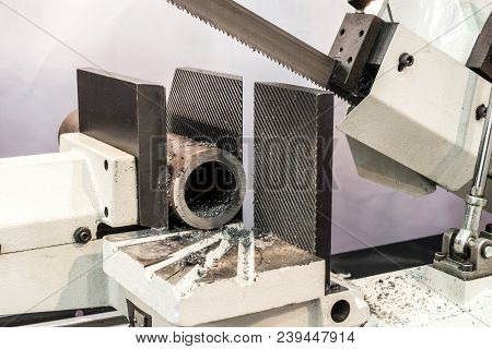 Automatic Bandsaw Sawing Metal Workpiece. Equipment For Cutting Metal Pipes And Other Steel Blanks.