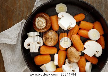 Stewed Cooking Healthy Food Concept. Raw Carrots, Leek And Mushrooms For Stewing In Cast-iron Frying