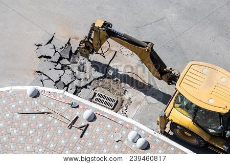 Big Jackhammer Drill Drilling Road.heavy Machinery Crushing Asphalt For Stormwater Drain Repair.