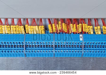 Lot Electrical Feed-through Terminals, Arranged In A Row. To Them Are Attached The Electric Wires Ma