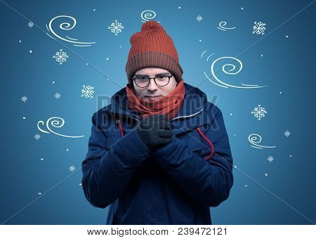 Young hipster frozen boy with doodled snowflakes and windy concept