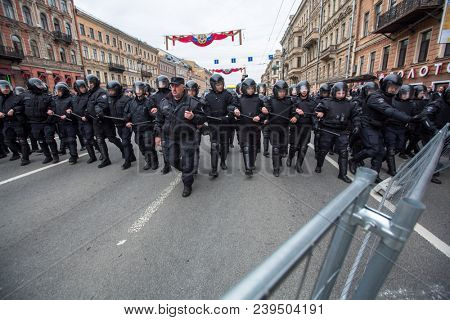 ST. PETERSBURG, RUSSIA - MAY 5, 2018: Police officers in riot gear block an Nevsky prospect during an opposition protest rally ahead of President Vladimir Putin's inauguration ceremony.