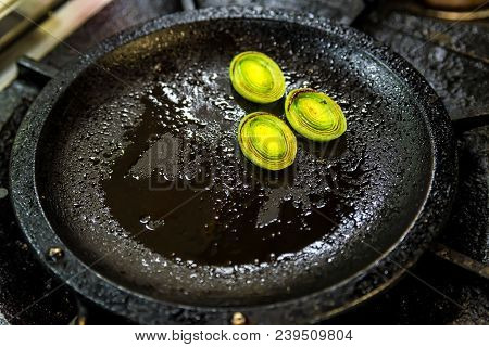 Close Up Small Round Slices Of Leek Roasted On Frying Pan For Cooking Salad