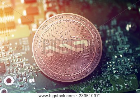 Shiny Copper Nxt Cryptocurrency Coin On Blurry Motherboard Background Token