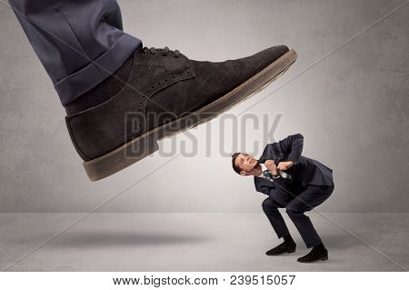 Young businessman illustrated inconsiderable by being trampled