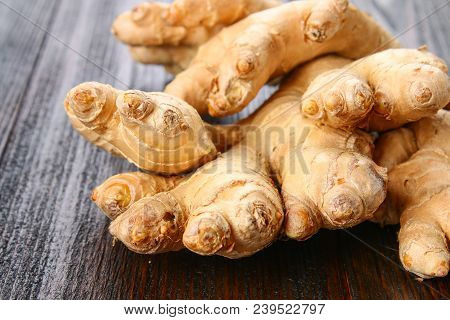 Spicy Root Of Ginger On A Wooden Table