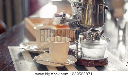 Close Up Of Siphon Vacuum, Coffee Cup And Siphon Vacuum Coffee Maker At Shop.