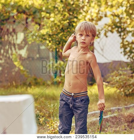 Concentrated Sporty Young Boy Training With Throwing Knife, Image With Square Aspect Ratio And Warm 