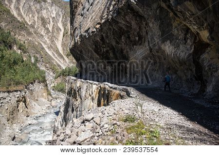 A Woman Trekking On The Marsiandi River Shore At The Annapurna Circuit Route, Nepal