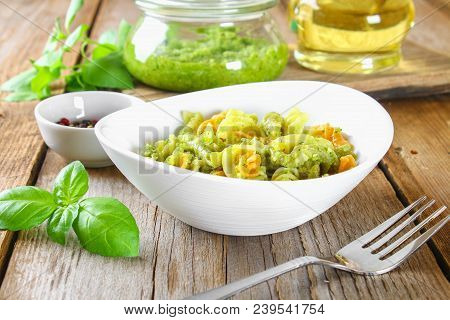 Pasta With Pesto Sauce On An Old Wooden Table