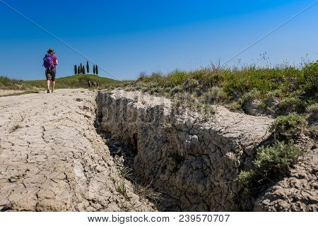 Asciano, Tuscany, Italy - Unknown People Walking Along The Famous White Roads