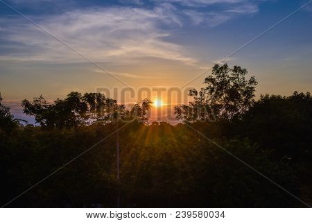 Sunset Over A Green Forest And Trees