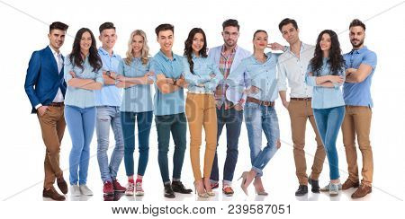 large team of casual men and women standing together on white background, looking confident and excited. 