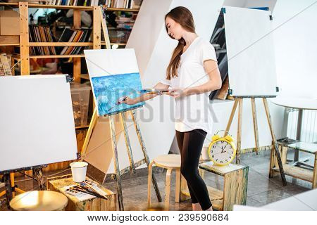 Painting Process At Workshop. Young Amateur Female Artist Painting A Seascape Filling The Inspiratio