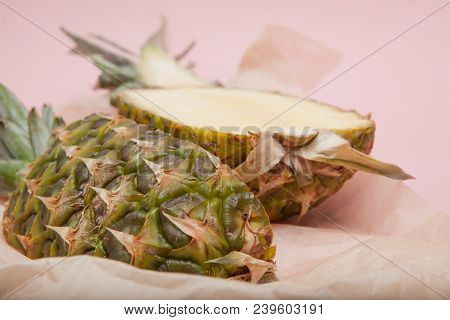 Half Cut Juicy Pineapple On A Pastel Pink Background. Minimal Summer Concept.