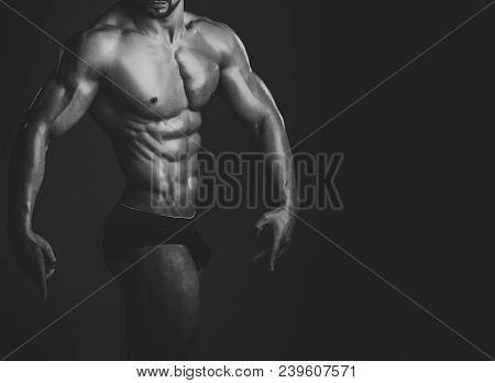 Dieting And Fitness, Healthy Lifestyle. Sport And Workout. Athletic Bodybuilder Man On Black Backgro
